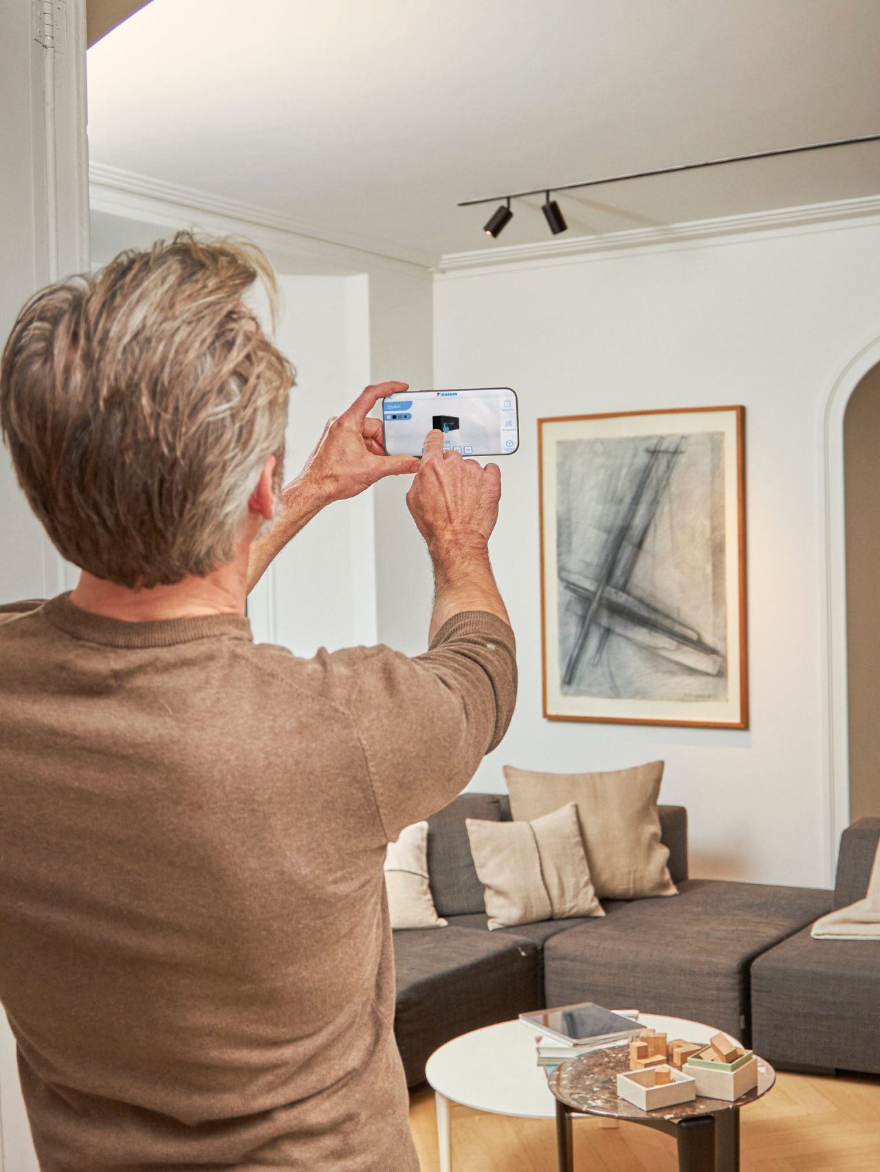 Man using an app to control his heating solution