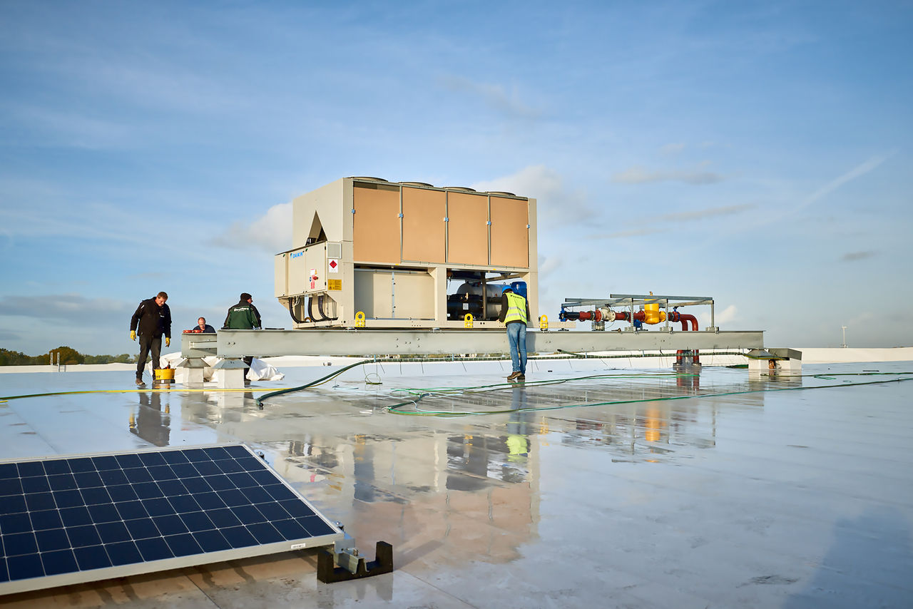 HVAC unit being moved on roof